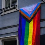 Progress Pride flag flown from an upstairs window